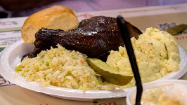 The quintessential Alabama plate of BBQ: hickory smoked chicken, cole slaw, potato salad and banana pudding waiting for dessert.