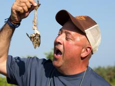 Andrew Zimmern samples pilot fish