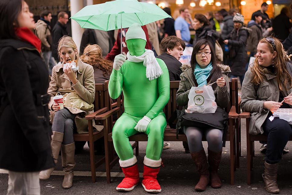 Street Performer in a Green Suit on London's Oxford Street
