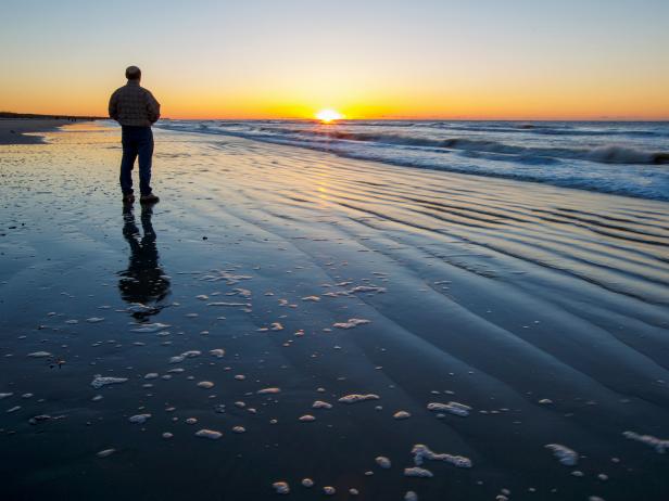 Man Standing on Isle of Palms Beach at Sunset