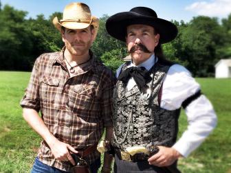 Josh Gates poses with a member of a 19th century gun club in Oklahoma