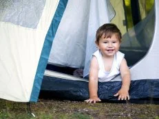 toddler in tent while camping