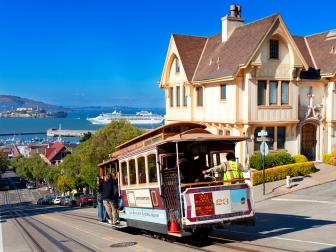 cable car, hyde street, san francisco, california, alcatraz in background, daytime