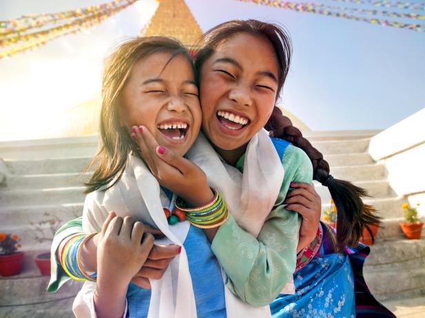 two sisters smiling, boudha temple, nepal, sun soaked,