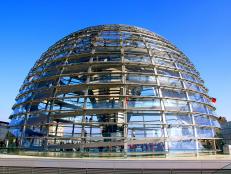 tall clear dome with spiraling staircase on top of government building in berlin during daytime