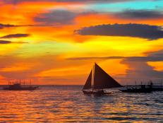 sunset with ships on ocean in the philippines
