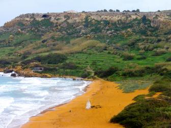 orange sand green hills blue ocean ramla bay gozo malta