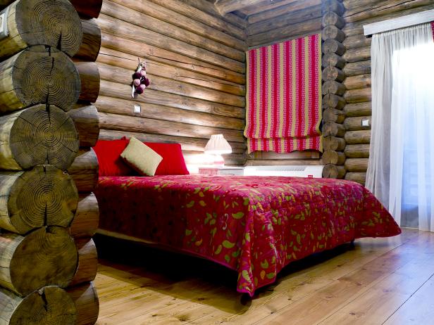 cabin with log walls and bed