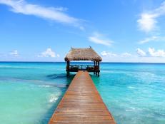 dock leading to covered cabana in the sea in the caribbean cancun