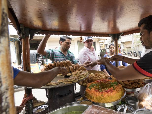 Andrew, KK and friend Jonty, purchase fried street foods in Hyderabad.