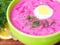 Cold beet soup with herbs and egg on the table