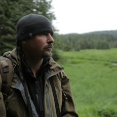 Host Casey Anderson waiting for bear to show up, as seen on Travel Channel's Finding Beast.