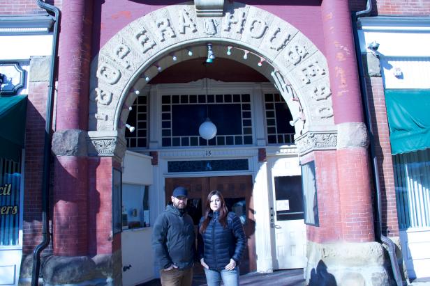 Hosts Jack Osbourne and Katrina Weidman posing in front of the entrance to Twin City Opera House in Ohio. As seen on Travel Channel's Portals To Hell.