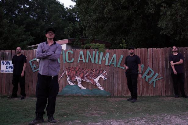 Zak and crew standing in front of entrance sign.