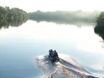 The crew heads off on the Rio Negro in Brazil on a boat as seen on Travel Channel's Lost in The Wild.