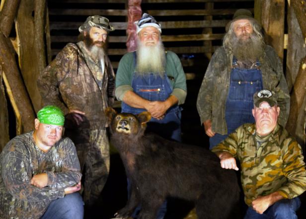 The team pauses for photo with trophy black bear that was hunted by a friend.