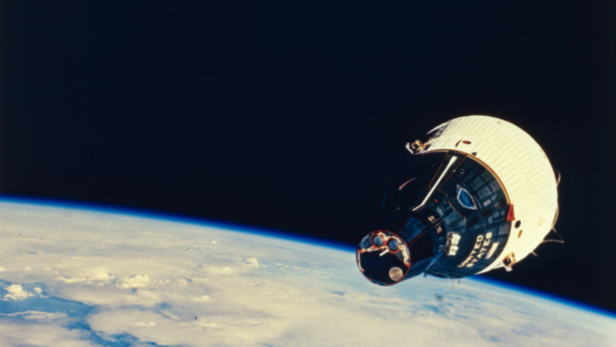 December 1965: The Gemini 7 space capsule orbits the earth during its 14-day manned mission.  