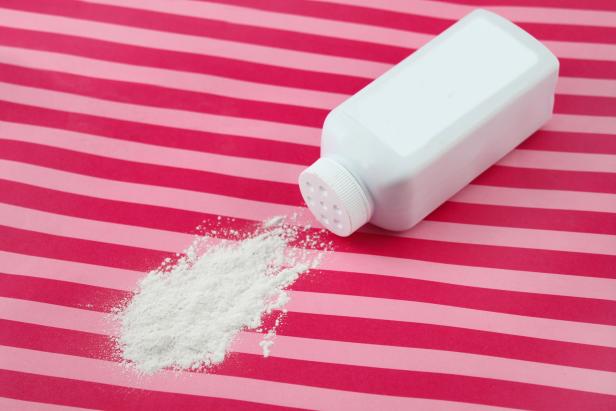 Spilled baby scented powder on striped background