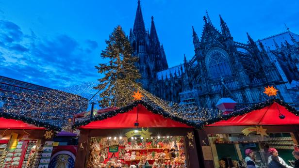 Cologne, Germany - December 17, 2015: Christmas market in front of the Cologne Cathedral. Tourist attraction visitited by many people.