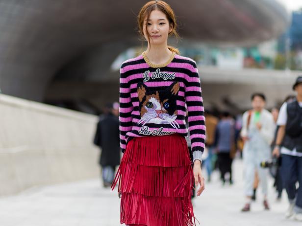 SEOUL, SOUTH KOREA - OCTOBER 21: A Korean model wearing a Gucci sweater and red skirt with fringes attends day 5 of HERA Seoul Fashion Week on October 21, 2016 in Seoul, South Korea. (Photo by Christian Vierig/Getty Images)