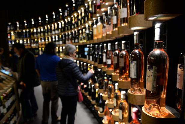 People look at bottles of wine as they visit La Cite du Vin (Wine Museum) as it opens its doors to the public in Bordeaux on June 1, 2016. 
La Cite du Vin opened its doors to the public on June 1. The 13 350 m2 compound offers thematics areas about the history and civilisations of wine around the world with digital and sensory exhibits. / AFP / MEHDI FEDOUACH        (Photo credit should read MEHDI FEDOUACH/AFP/Getty Images)