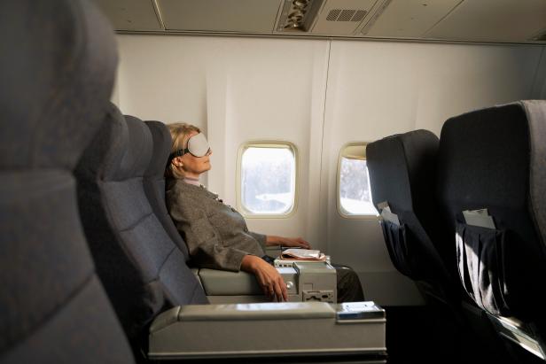 Businesswoman relaxing on airplane