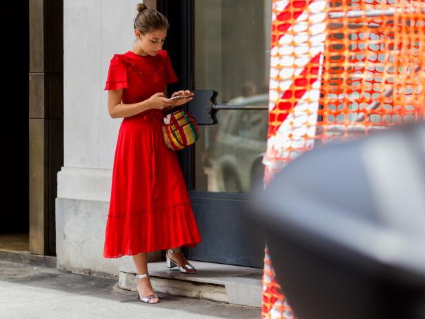 MILAN, ITALY - JUNE 19: Jenny Walton wearing a red vintage dress and bag and Prada shoes outside Ferragamo during the Milan Men's Fashion Week Spring/Summer 2017 on June 19, 2016 in Milan, Italy. (Photo by Christian Vierig/Getty Images)