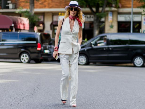 MILAN, ITALY - JUNE 21: Elina Halimi wearing a white vest and pants and hat and red bandana outside Armani during the Milan Men's Fashion Week Spring/Summer 2017 on June 21, 2016 in Milan, Italy. (Photo by Christian Vierig/Getty Images)