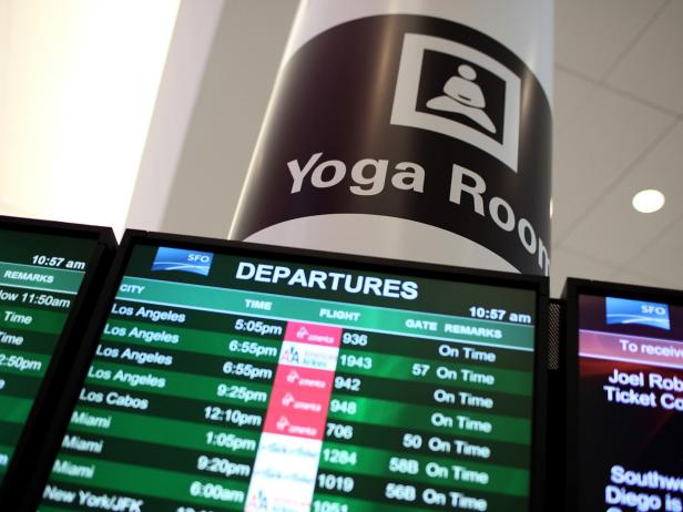 SAN FRANCISCO, CA - JANUARY 26:  A sign is posted near the departures monitor for the new Yoga Room at San Francisco International Airport's terminal two on January 26, 2012 in San Francisco, California.  San Francisco International Airport opened the doors to what they are saying is the first-in-the-world yoga room inside an airport terminal. The small room in the newly constructed terminal two is dimly lit with soothing blue light provides weary travelers a place to relax or practice yoga poses once they have clearing security. The yoga room is open from 4:30 a.m. to 12:30 a.m.  (Photo by Justin Sullivan/Getty Images)