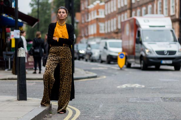 LONDON, ENGLAND - SEPTEMBER 17: Giovanna Battaglia wearing a yellow button shirt, leo print pants and black cardigan outside of JW Anderson during London Fashion Week Spring/Summer collections 2017 on September 17, 2016 in London, United Kingdom. (Photo by Christian Vierig/Getty Images)