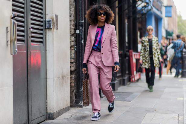 LONDON, ENGLAND - SEPTEMBER 18: Fashion Director Instyle Germany Jan-Michael Quammie wearing a pink suit, Louis Vuitton bag and Vans outside Mary Katrantzou during London Fashion Week Spring/Summer collections 2017 on September 18, 2016 in London, United Kingdom. (Photo by Christian Vierig/Getty Images)