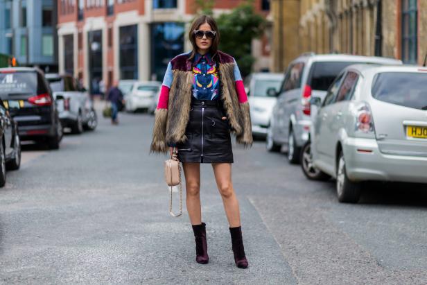 LONDON, ENGLAND - SEPTEMBER 18: Paola Alberdi wearing Jimmy Choo sunglasses, a MSGM fur jacket, Tsumori Chisato button shirt, Isabel Marant leather skirt, Chanel bag outside Topshop during London Fashion Week Spring/Summer collections 2017 on September 18, 2016 in London, United Kingdom. (Photo by Christian Vierig/Getty Images)