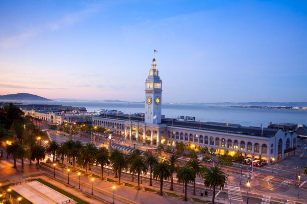 The San Francisco Ferry Building at dusk on Embarcadero and Market Street.