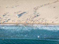 Santa Monica beach, drone view - People sunbathing on the beach and swimming in the ocean