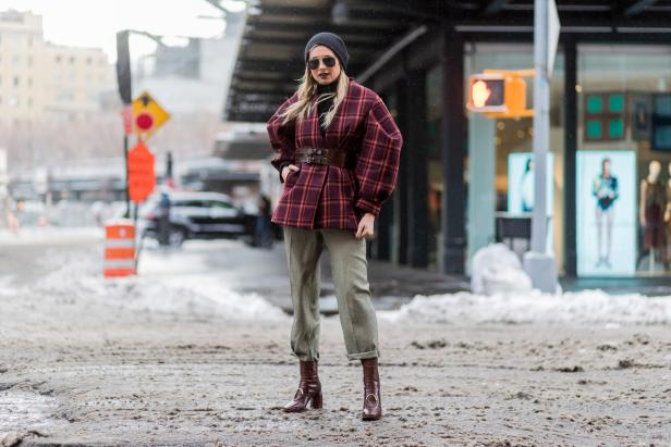 NEW YORK, NY - FEBRUARY 09:  Danielle Bernstein wearing cropped olive pants, boots, checked red jacket, sunglasses, beanie outside Creatures of Comfort on February 9, 2017 in New York City.  (Photo by Christian Vierig/Getty Images)