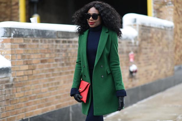 NEW YORK, NY - FEBRUARY 09:  A guest is seen wearing a green coat, blue dress and red bag outside of the Tadashi Shoji show during New York Fashion Week: Women's Fall/Winter 2017  on February 9, 2017 in New York City.  (Photo by Daniel Zuchnik/Getty Images)