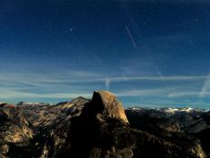 Lit by a very bright half moon, night becomes day during this 30-second time exposure view of the stars and aircraft in the skies over Half Dome at 9:35 p.m. from a Glacier Point vantage point in Yosemite National Park  May 20, 2013  (Photo by Mark Boster/Los Angeles Times via Getty Images)