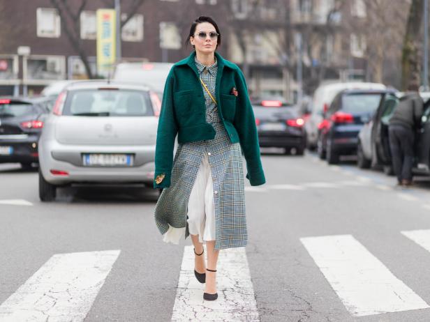MILAN, ITALY - FEBRUARY 23: A guest wearing checked coat, green jacket outside Fendi during Milan Fashion Week Fall/Winter 2017/18 on February 23, 2017 in Milan, Italy. (Photo by Christian Vierig/Getty Images)