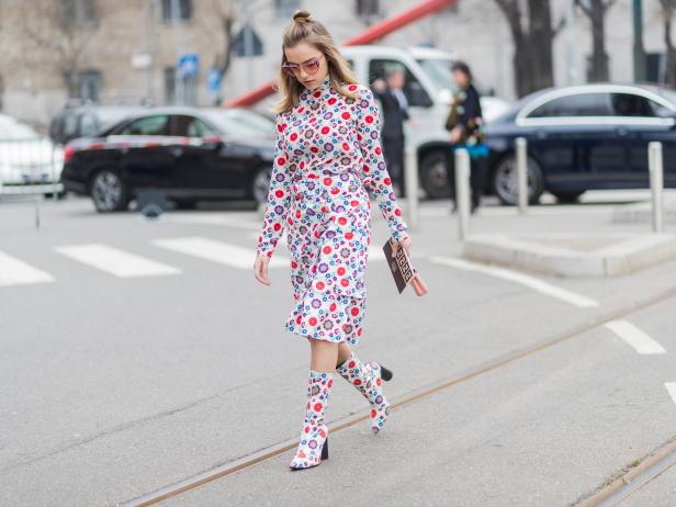 MILAN, ITALY - FEBRUARY 23: A guest wearing a dress with print and boots outside Fendi during Milan Fashion Week Fall/Winter 2017/18 on February 23, 2017 in Milan, Italy. (Photo by Christian Vierig/Getty Images)