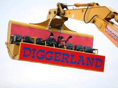 Young visitors to Diggerland enjoy a ride on a spinning JCB arm, near Rochester in Kent,Tuesday, December 20, 2005. For children or adults, operating full-scale machinery, is the key attraction of the 24-acre dirt park, about an hour's drive
south of London in Kent. Photographer: Graham Barclay/Bloomberg News