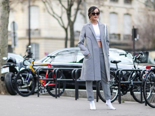 PARIS, FRANCE - MARCH 02:  Chriselle Lim wears a white top, a long jacket, white shoes, black and white pants, outside the Paco Rabanne show, during Paris Fashion Week Womenswear Fall/Winter 2017/2018, on March 2, 2017 in Paris, France.  (Photo by Edward Berthelot/Getty Images)