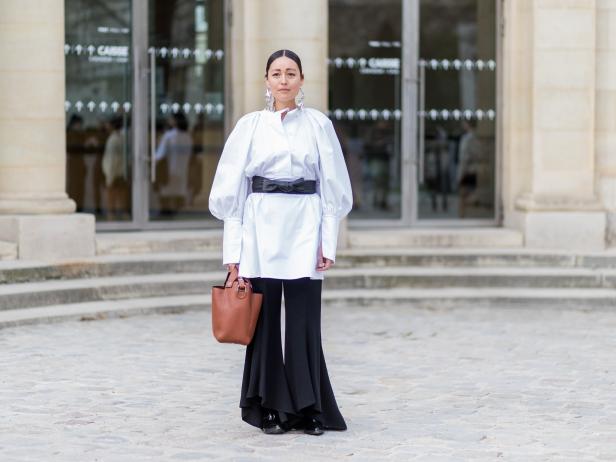 PARIS, FRANCE - MARCH 03: Rachael Wang wearing a white top, brown bucket bag, wide leg black pants outside Dior on March 3, 2017 in Paris, France. (Photo by Christian Vierig/Getty Images)