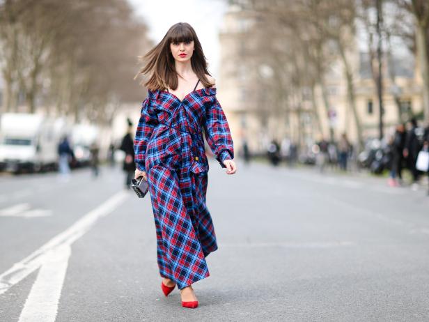 PARIS, FRANCE - MARCH 03:  Kristi Gogsadze, fashion blogger from La Georgienne, wears an Anna October purple checked dress, a Karl Lagerfeld clutch, and Christian Louboutin red shoes, outside the Dior show, during Paris Fashion Week Womenswear Fall/Winter 2017/2018, on March 3, 2017 in Paris, France.  (Photo by Edward Berthelot/Getty Images)