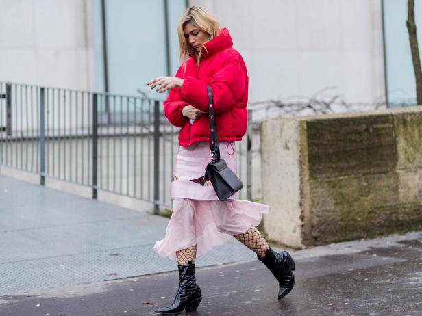 PARIS, FRANCE - MARCH 06:  A guest wearing a red down feather jacket, pink skirt outside Valentin Yudashkin on March 6, 2017 in Paris, France. (Photo by Christian Vierig/Getty Images)