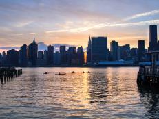 Beautiful sunset image of the East River with kayakers, Manhattan skyline in the background. Taken from LIC in Queens.