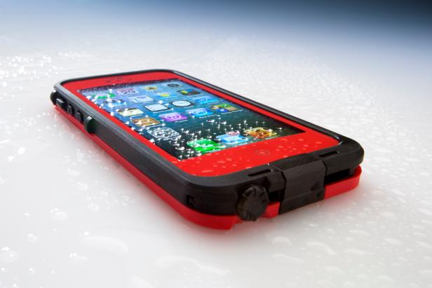 San Diego, California, United States - July 29th, 2013: This is the Apple iphone 5 in a red lifeproof case. It was photographed in the studio at a low angle and spritzed with water. Apple Inc. is the leading manufacturer in smart phones. It recently released the new IOS 7 operating system. Lifeproof caes enable the iPhone to be submersed up to 6 1/2 feet of water and protect it from falls and dirt as well.
