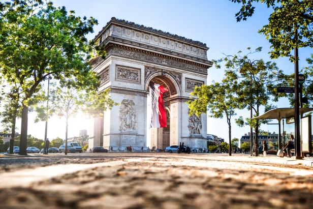 View of Paris Arc de Triomphe at night during the 14th of July, National Holiday.