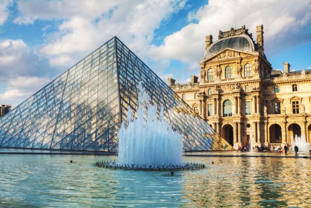 PARIS - OCTOBER 9: The Louvre Pyramid on October 9, 2014 in Paris, France. It serves as the main entrance to the Louvre Museum. Completed in 1989 it has become a landmark of Paris.