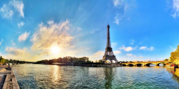 Beautiful 180 degree HDR panorama at sunrise in spring of the Eiffel tower at the river Seine in Paris, France