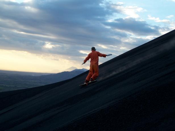 CORDILLERA DE LOS MARIBIOS, NICARAGUA - UNDATED: A boarder makes their way down the Cerro Negro volcano in the Cordillera de los Maribios mountain range in Nicaragua. What do you do when you have snowboarded down all of the mountains that Europe and North America have to offer? Head to Nicagua and board a volcano! Cerro Negro, (726 meters) is Central America's youngest volcano and has been one of the most active volcanoes in Nicaragua. The Bigfoot Hostel in Leon offers it's guests a trip to hike to the top of the volcano and then board the 500m down at speeds of up to 80kmh. (Photo by Bigfoot Hostel / Barcroft Media / Getty Images)